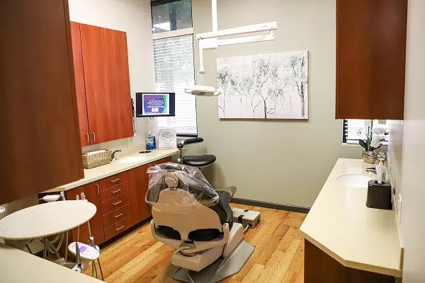 Dental operatory with chair, equipment, cabinets, and treatment area at Affinity Dental Queen Creek